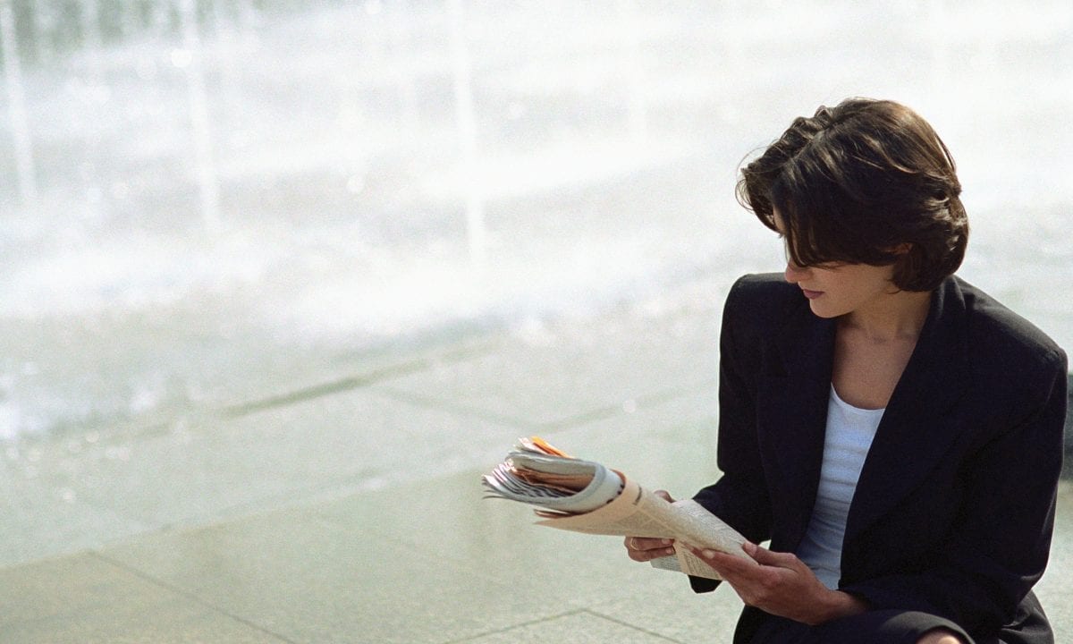 Business woman reading paper